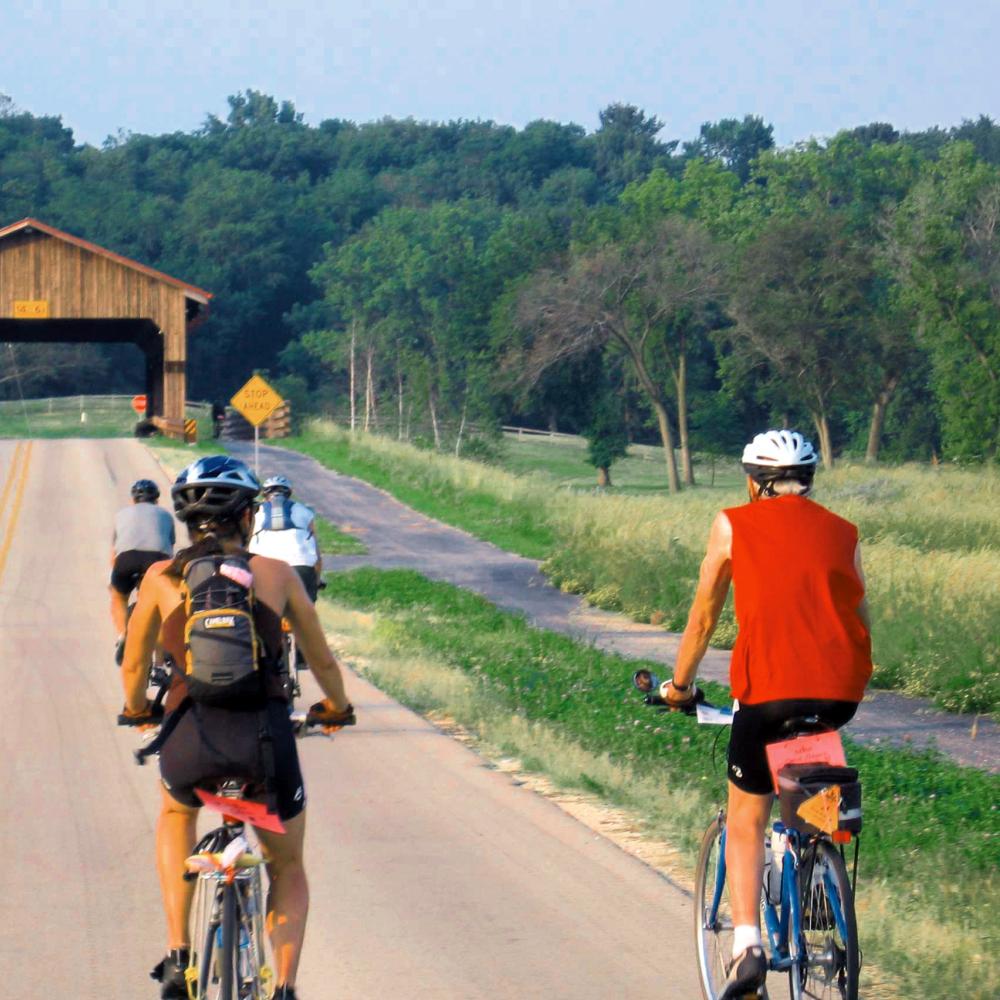 Photograph of two people on bikes on a road
