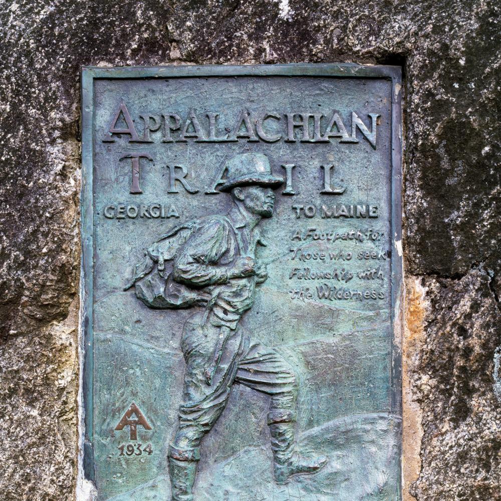 Photo of a dark green plaque which marks the beginning of the Appalachian trail.