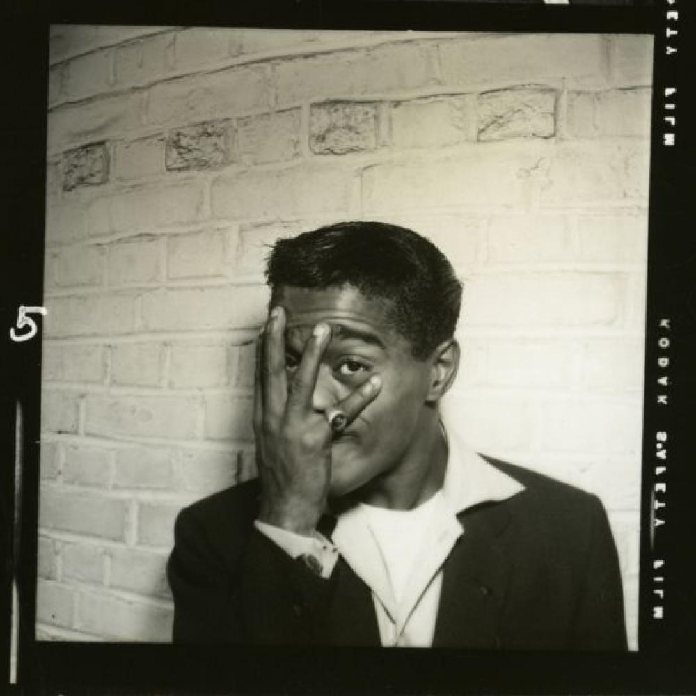 A backstage photo of Sammy Davis Jr. playfully blocking his face with his hand