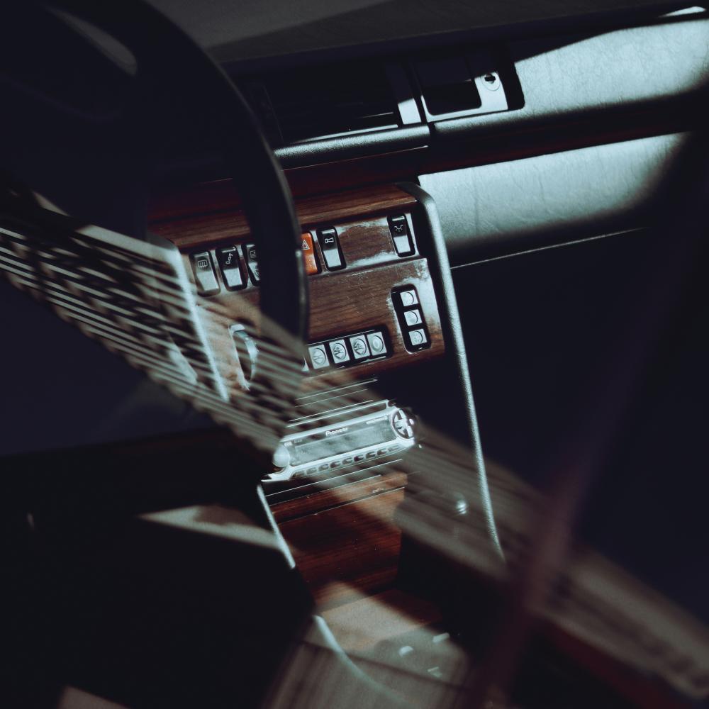 Photograph of a dashboard and glove compartment in an older car.