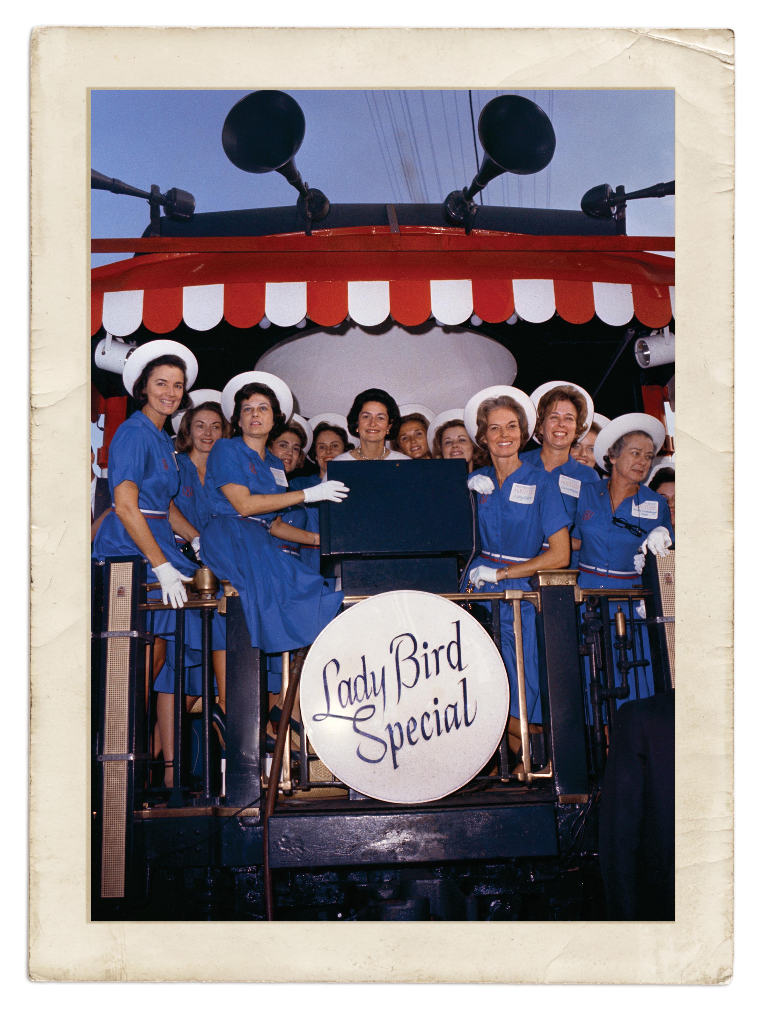 Photograph of women in blue dresses with Lady Bird Johnson