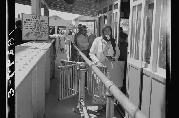 people lining up at an immigration station