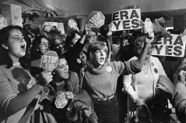 Crowd of women holding "ERA yes" and "stop ERA" signs