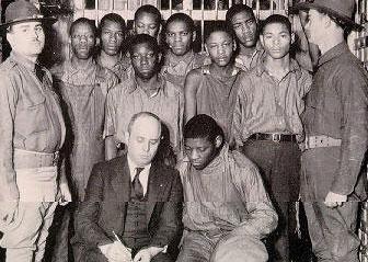 The Scottsbro Boys, with attorney Samuel Leibowitz, under guard by the state militia, 1932