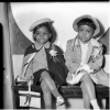 Two young sisters seated on bench in Harris Studio, c. 1942