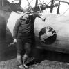 George Ostrom with his plane with Wyoming's bucking horse symbol