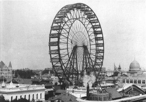 Ferris Wheel with fair buildings in the foreground and background