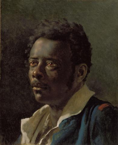Portrait of Black man in loose collared shirt and blue jacket