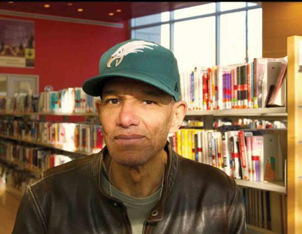 Photo of Carl Chandler in a library. 