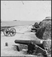 black and white photo of confederate artillery, including a cannon and wheeled wagon for transport