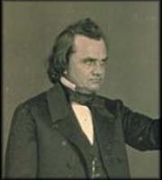 Douglas in a black suit and white shirt, hair combed back, reaching out his arm to the side and looking to his left