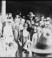 Black and white photo of Eleanor Roosevelt amid a crowd in Arthurdale, West Virginia.