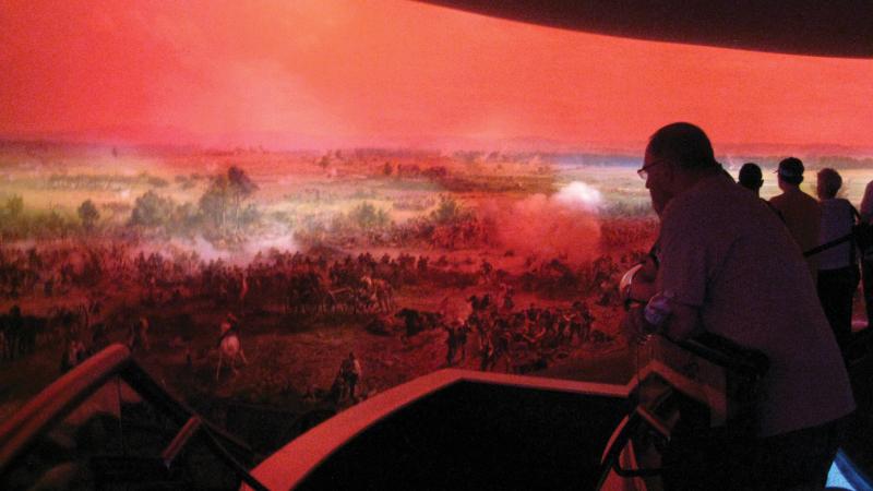 Photograph of a man viewing panoramic piece of art