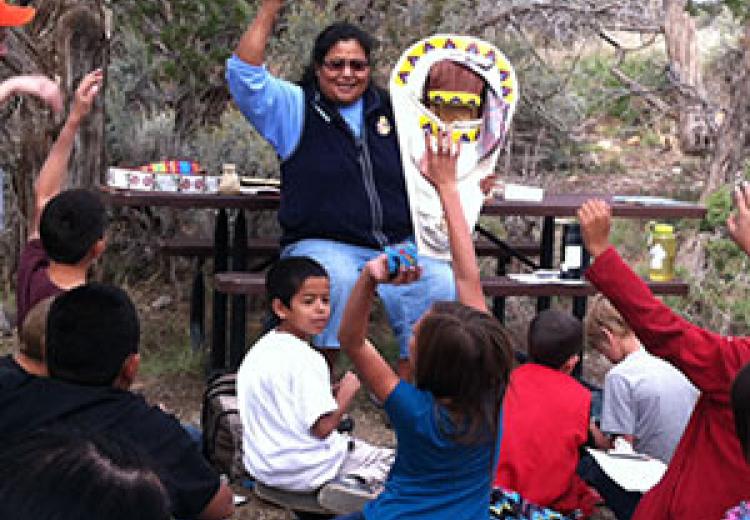 Students learning about Ute cultural artifact