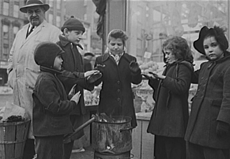 Italian American children warming their hands outside a New York fruit store