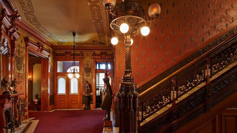 entryway and staircase of a house, orange wallpaper