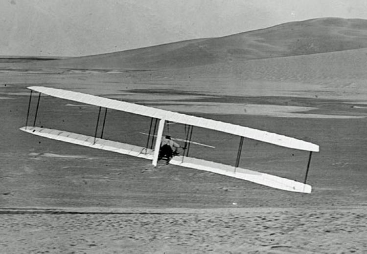 Rear view of Wilbur Wright making a right turn with the Wright Glider