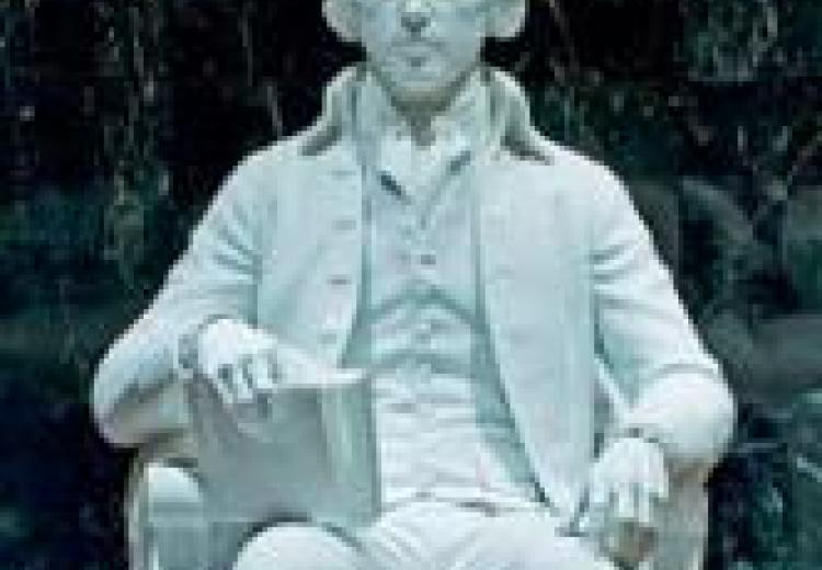 white statue of madison, seated, holding a book in his right hand
