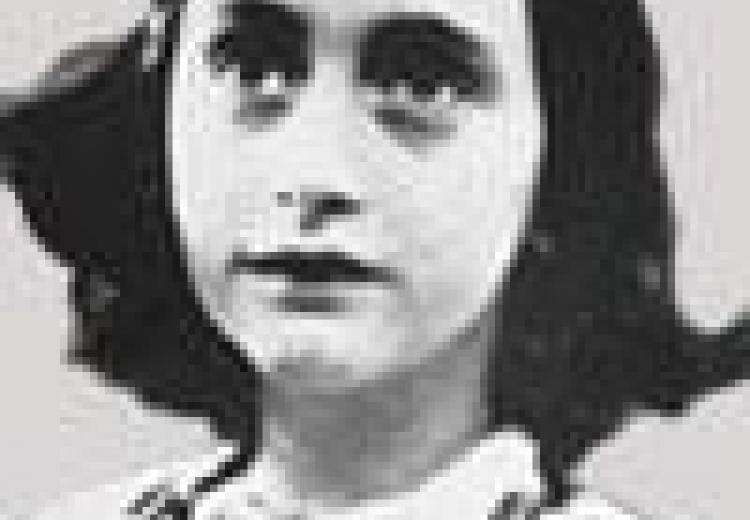 Anne Frank, with short dark hair, in a white dress, photo taken from shoulders up