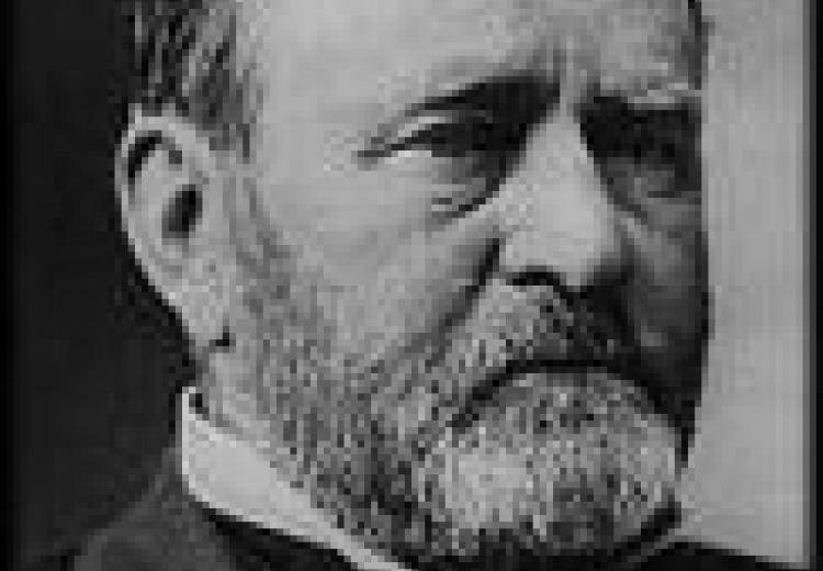 photo of grant's face and shoulders, bearded, wearing a tuxedo