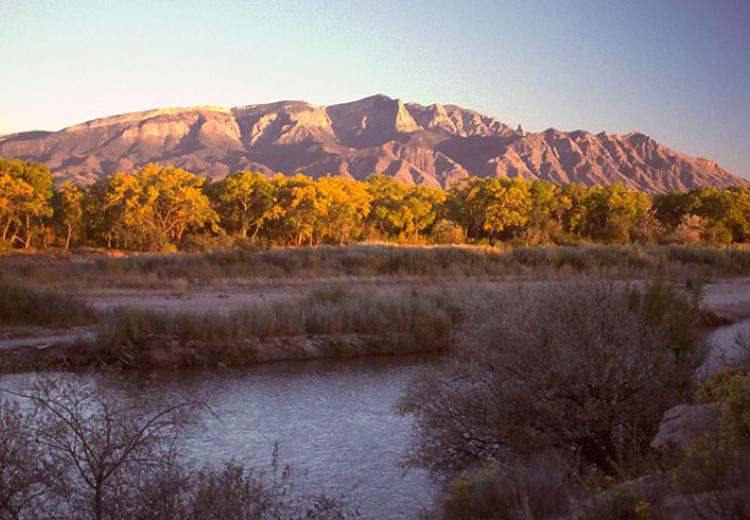 Photograph of the Sandia Mountains at sunset overlooking the Rio Grande