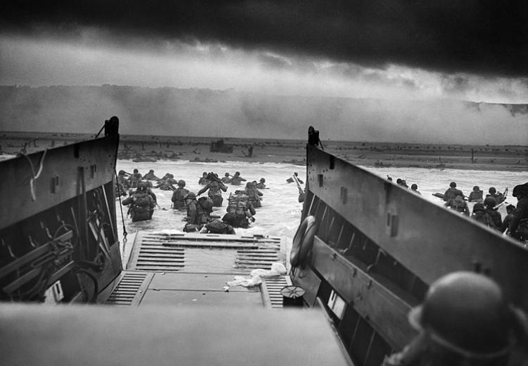U.S. Troops wading through water and Nazi gunfire during the D-day landing on June 6, 1944.