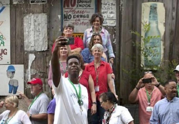 Color photograph of people taking pictures