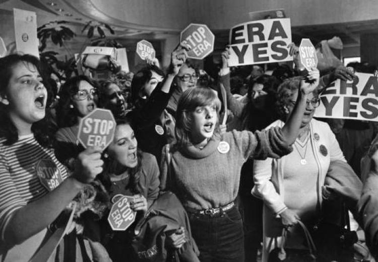Crowd of women holding "ERA yes" and "stop ERA" signs