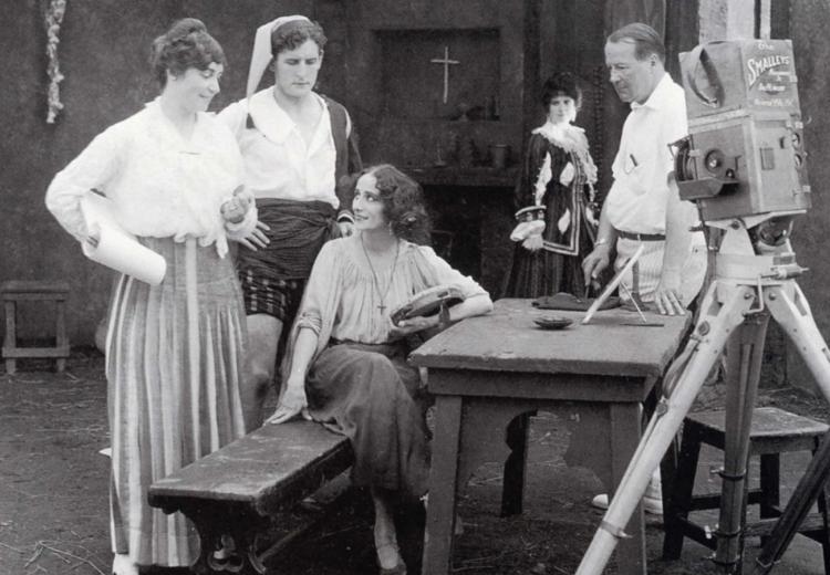 Black and white photograph of Lois Weber (left) directing Anna Pavlova and Douglas Gerrard on the set of The Dumb Girl of Portici (1916).