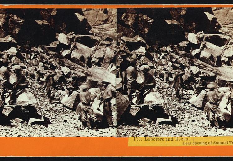 stereograph shows laborers and rocks at opening of tunnel